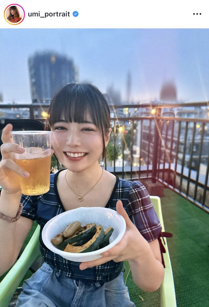 ビール片手に笑顔を見せる